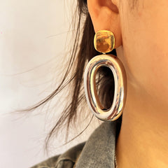 Two-tone geometric drop earrings with open oval detail – Nisdy