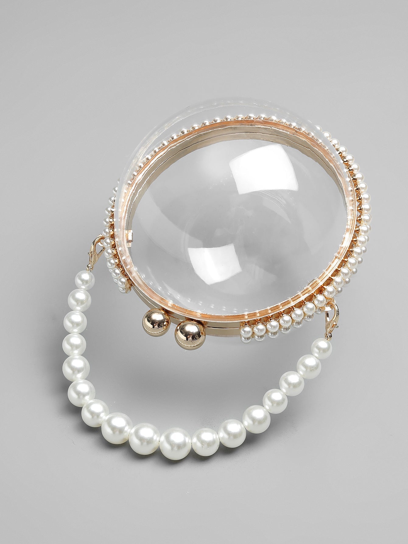 Circular clear bag with pearl handle and rhinestone accents - Lildu