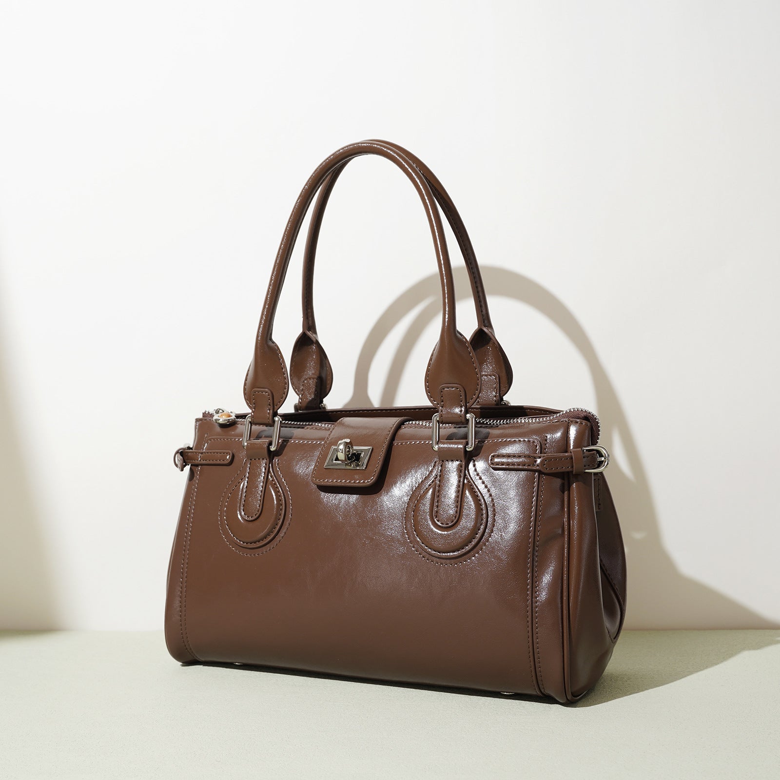 structured patent shoulder bag with buckle detail - AMIRDA