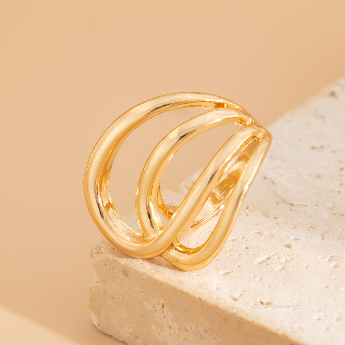 Open triple-loop statement ring with sculptural curve - Nulgi