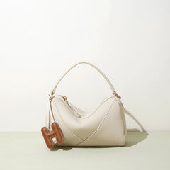 curved shoulder bag with contrast charm detail – MIIRA