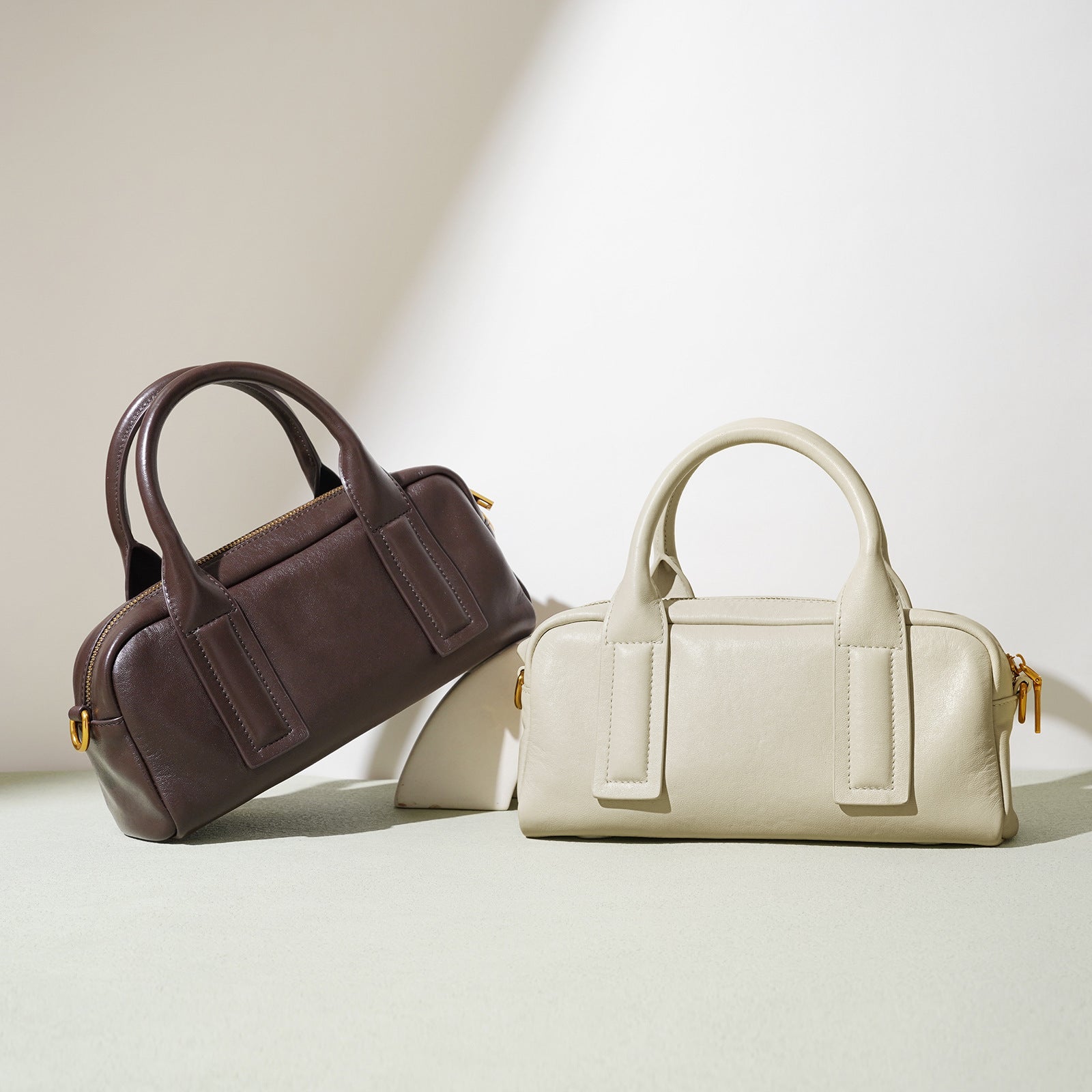Structured top-handle handbag with bold strap detailing - LUNCA