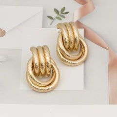 Twisted rope hoop earrings with interlocking loops – Nilker