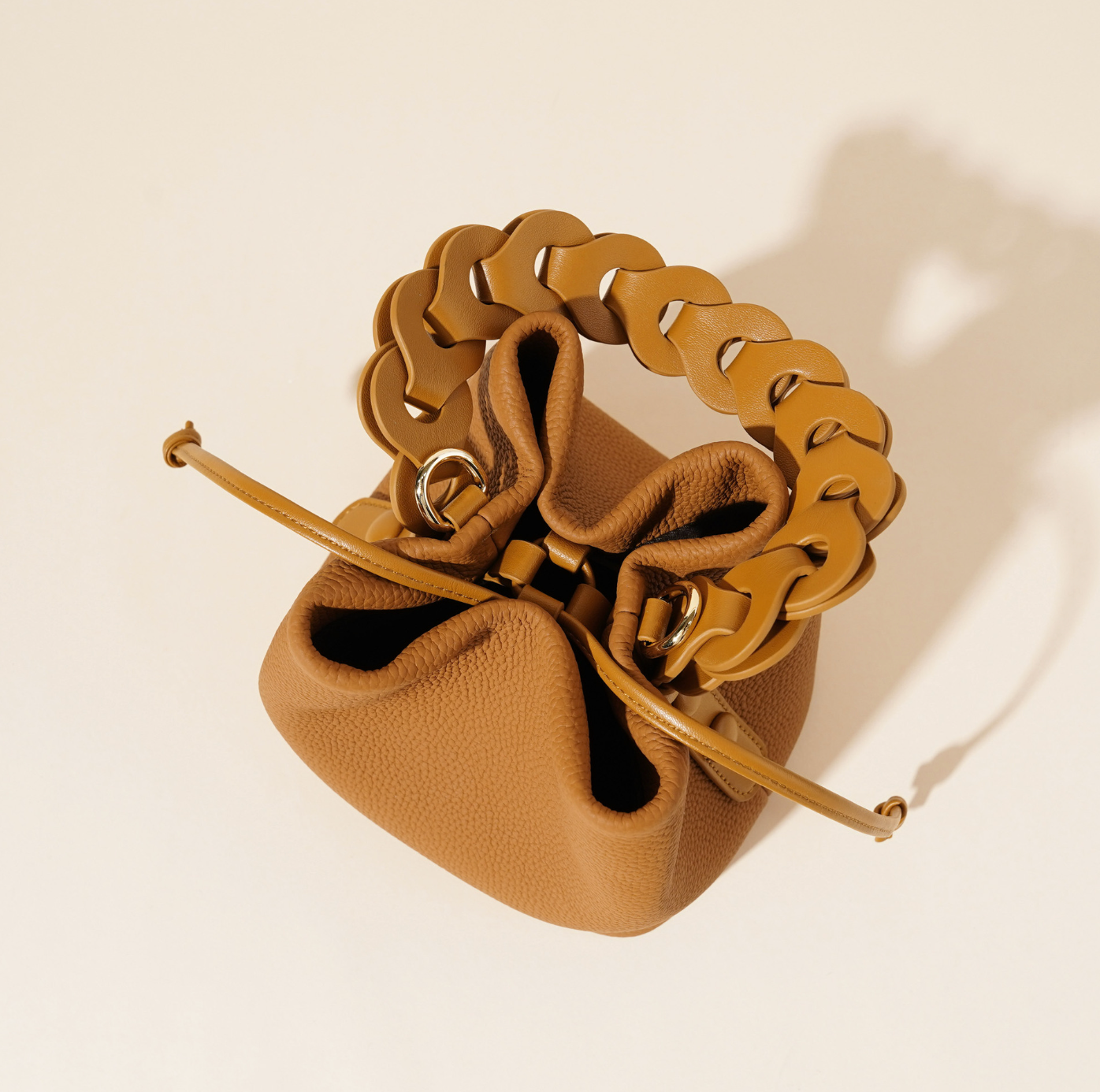ivory pebbled leather bucket bag with braided top handle – CALISTA