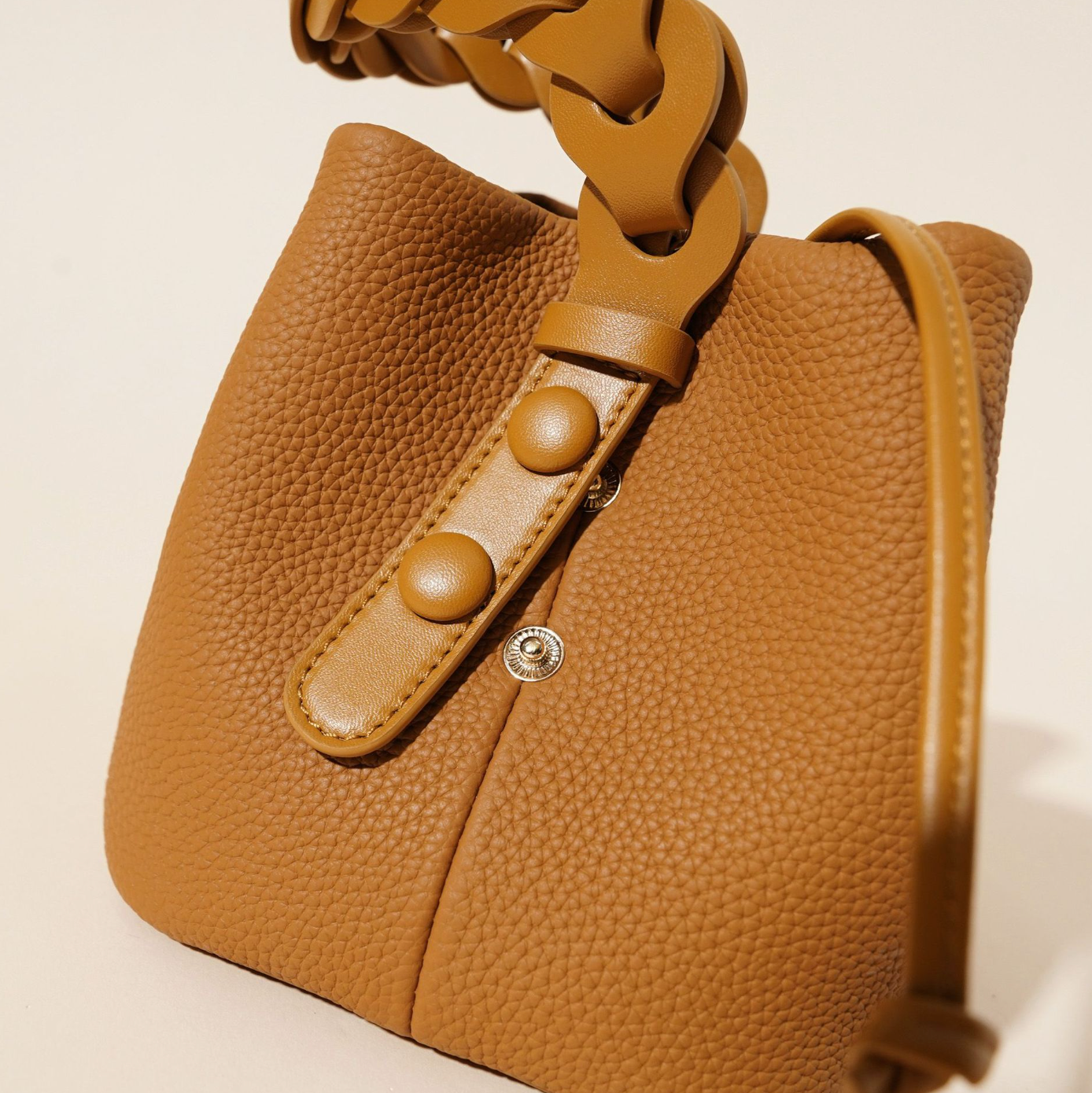 ivory pebbled leather bucket bag with braided top handle – CALISTA