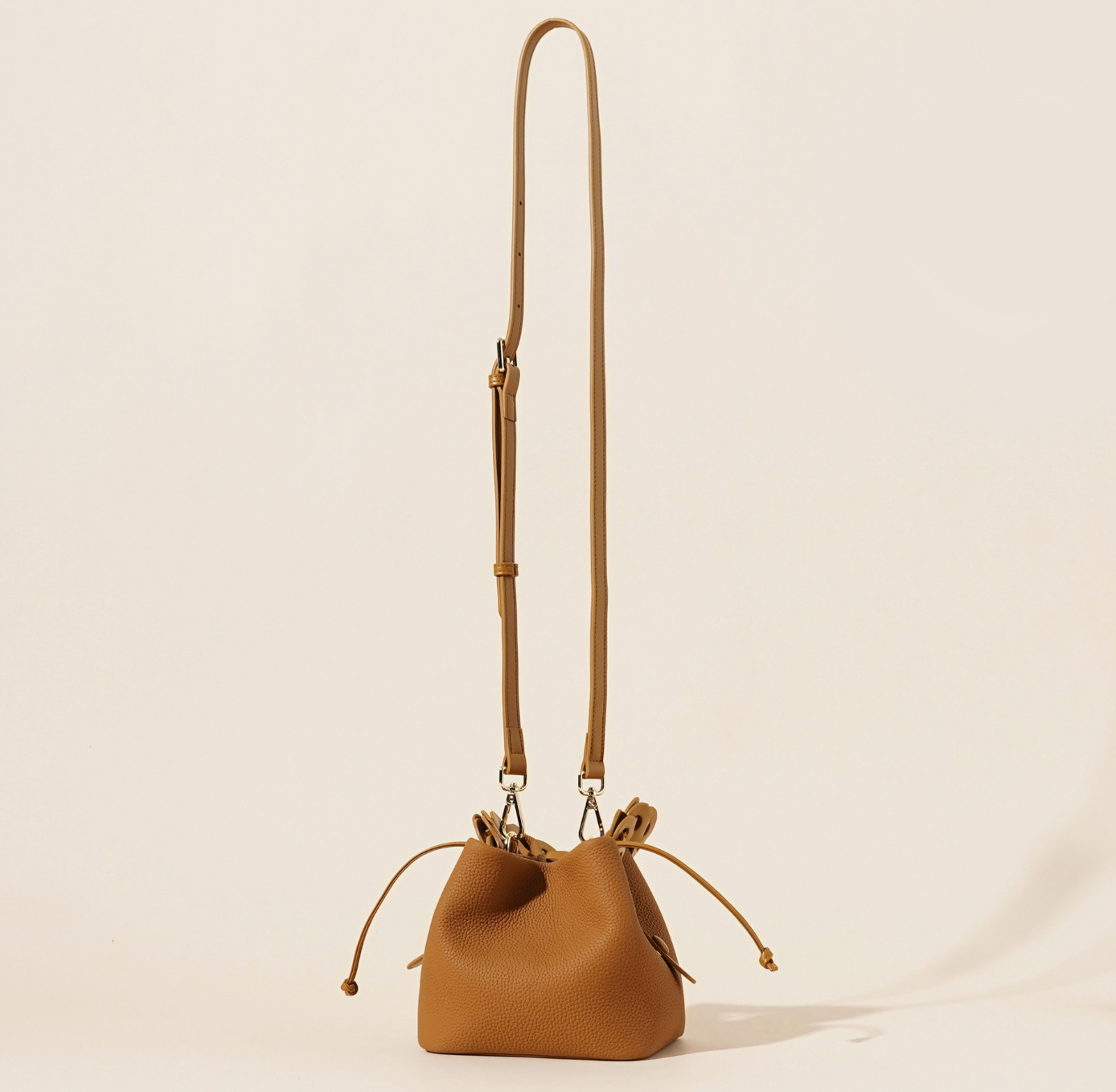 ivory pebbled leather bucket bag with braided top handle – CALISTA