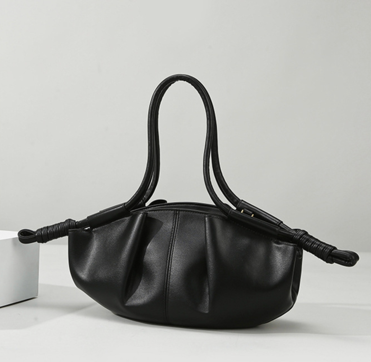 ruched crescent bag with knotted handles – NYRA
