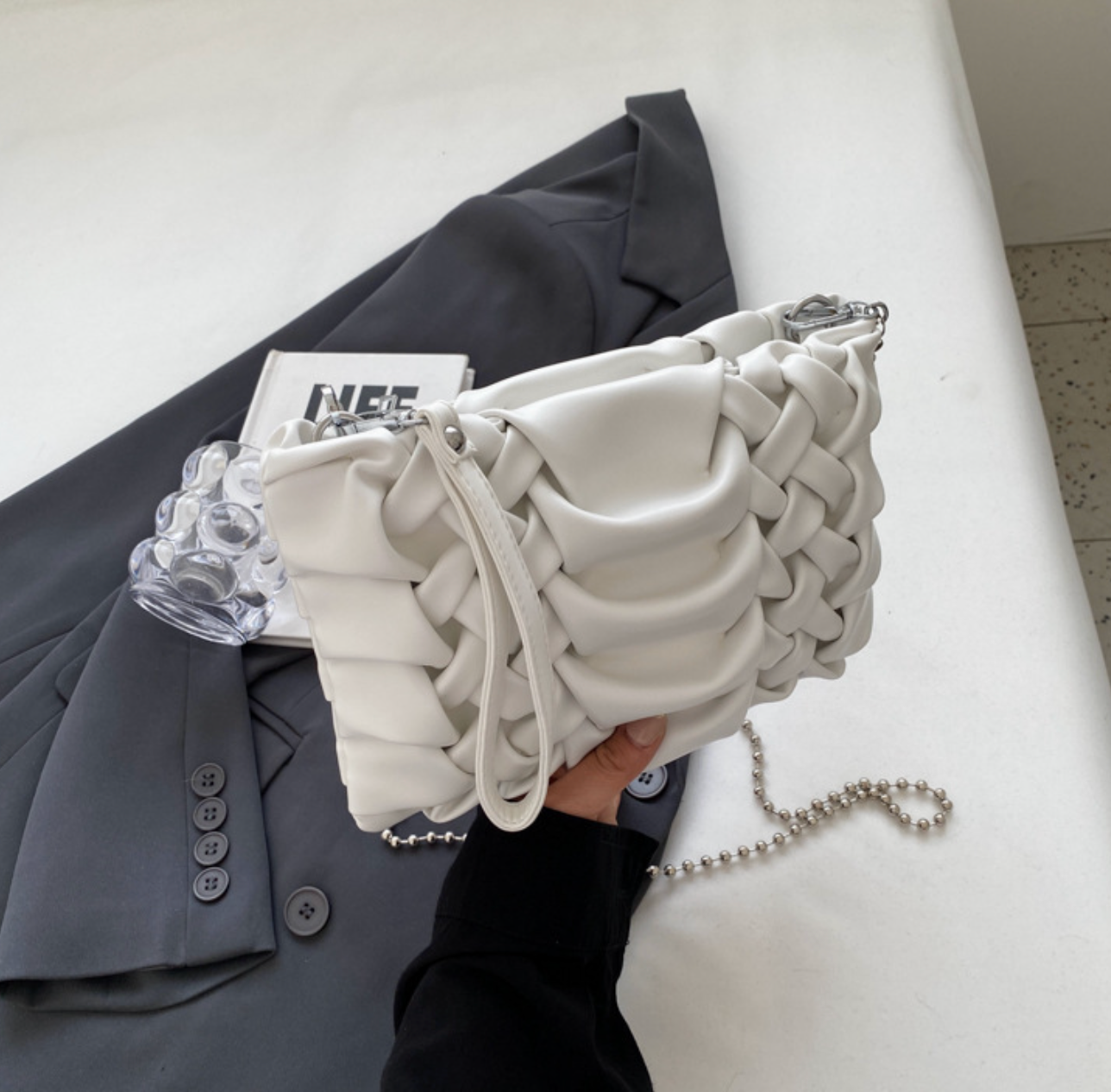 woven clutch with sculpted leather detail – FAYE