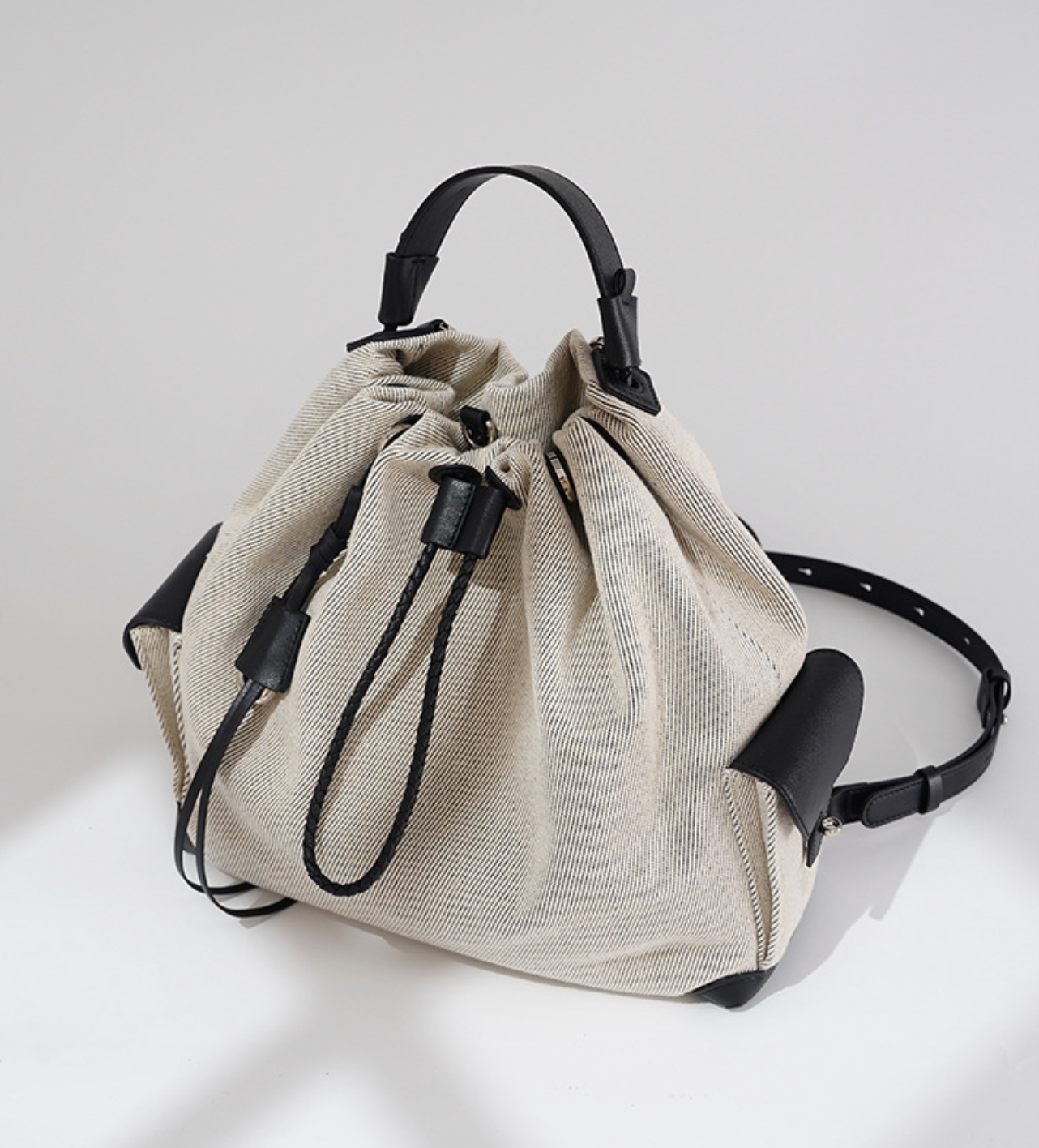 striped canvas drawstring bucket bag with leather trims – NOIIR