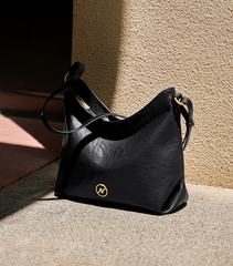 slouchy leather shoulder bag with gold emblem – AURX