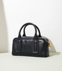 structured mini barrel bag in polished black – VERN