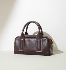 structured mini barrel bag in polished black – VERN