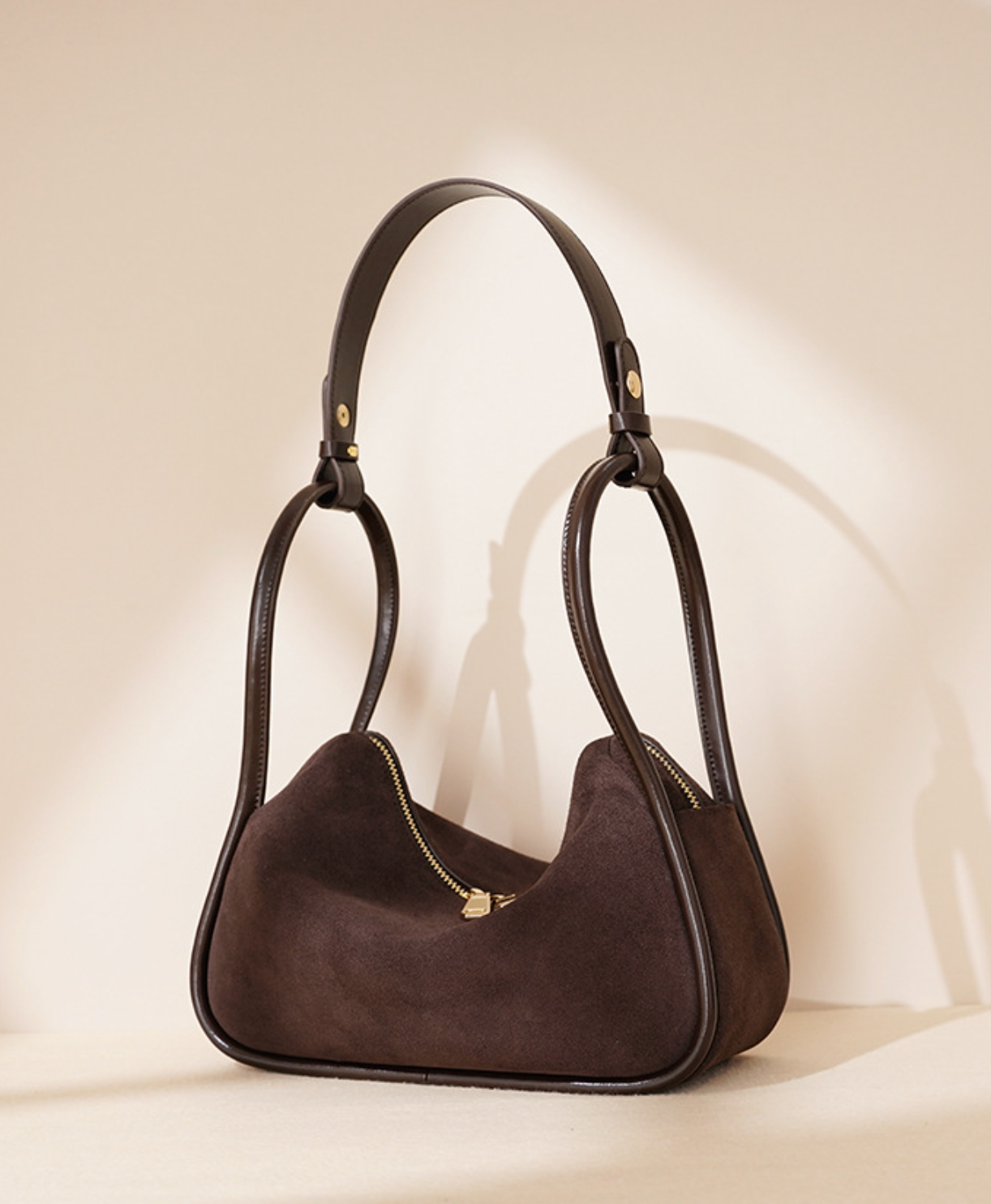 curved suede shoulder bag with gold twist lock – VIOLETTE