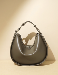 crescent-shaped leather shoulder bag with top zip – OLIVEA